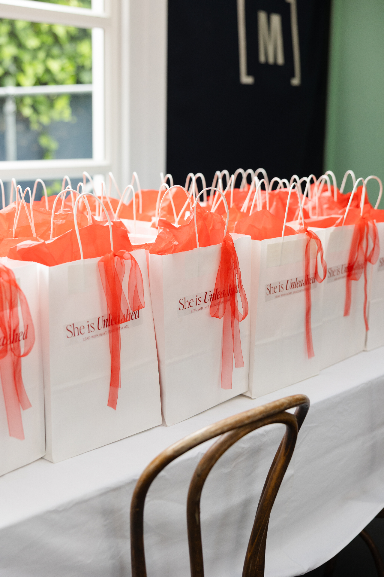 She Is Unleashed goodie bags lined up ready for guests