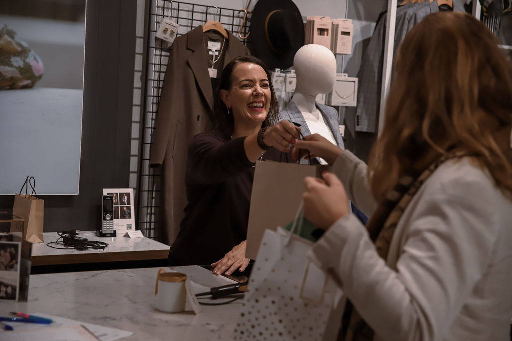 A goodie bag being handed over at the counter