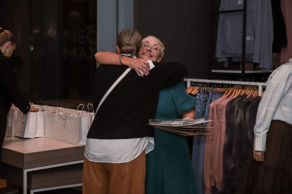 A warm hug between guests at the event