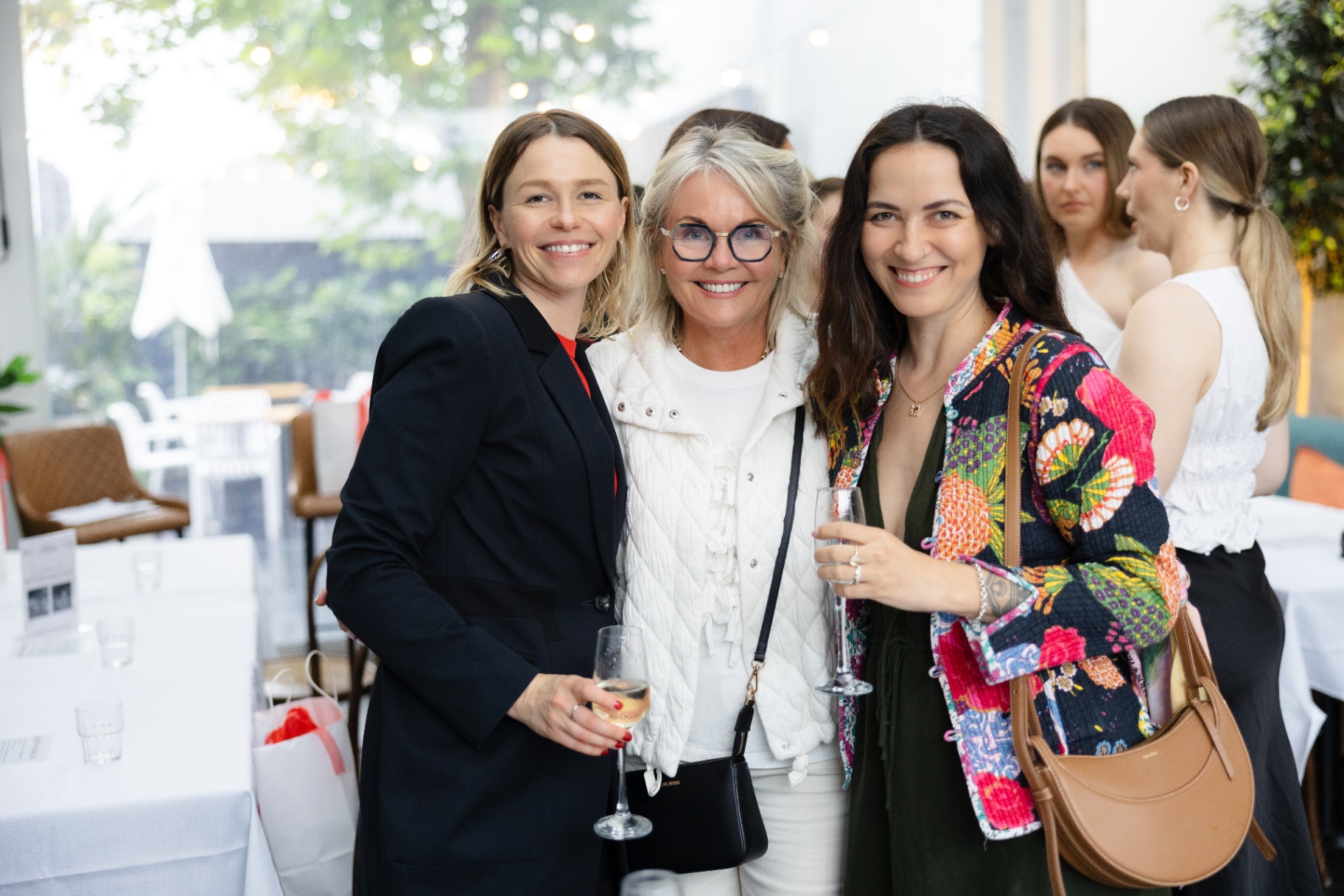 Three friends posing together at Better Together Auckland
