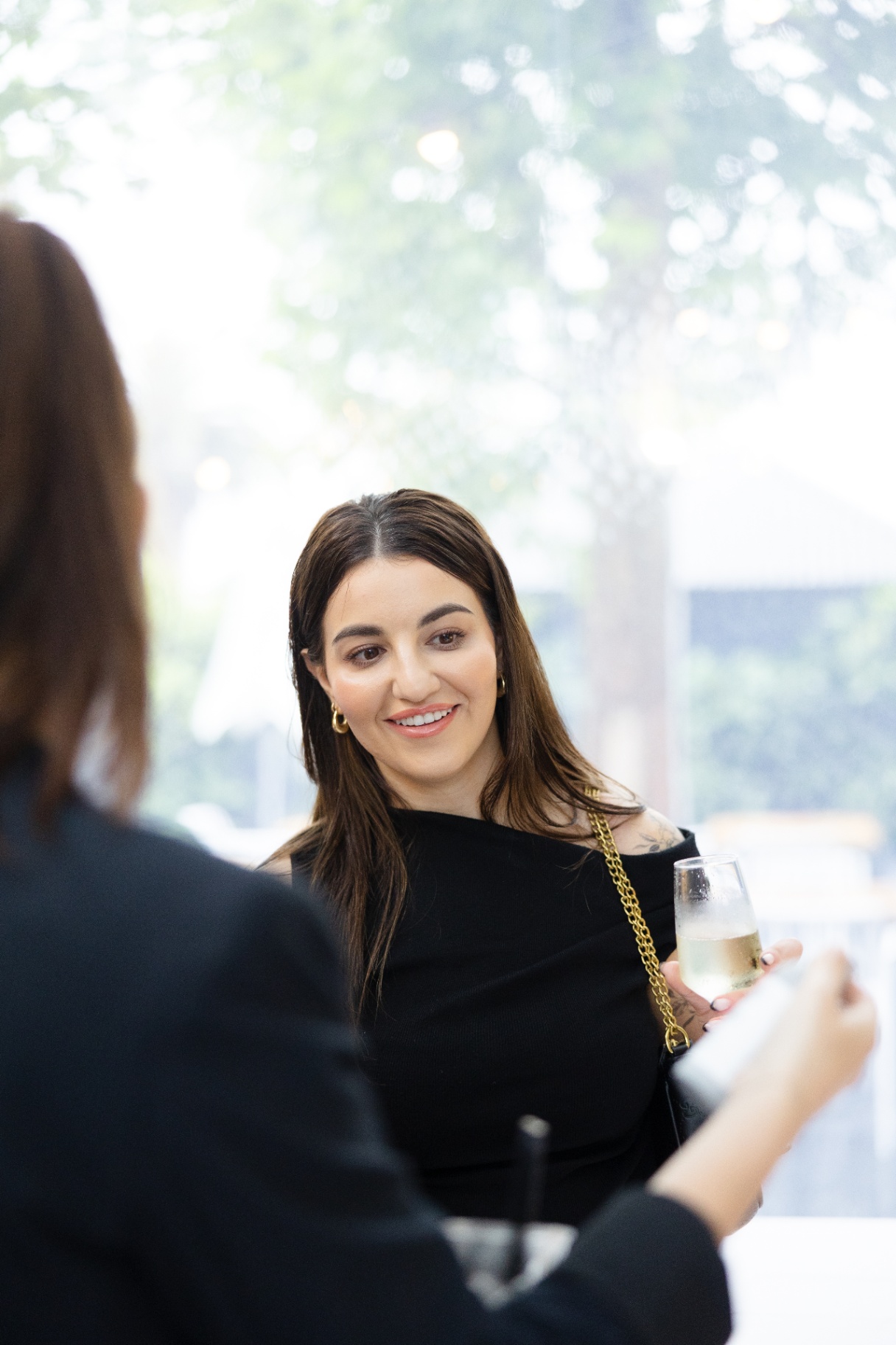 A guest smiling across the table during the panel discussion