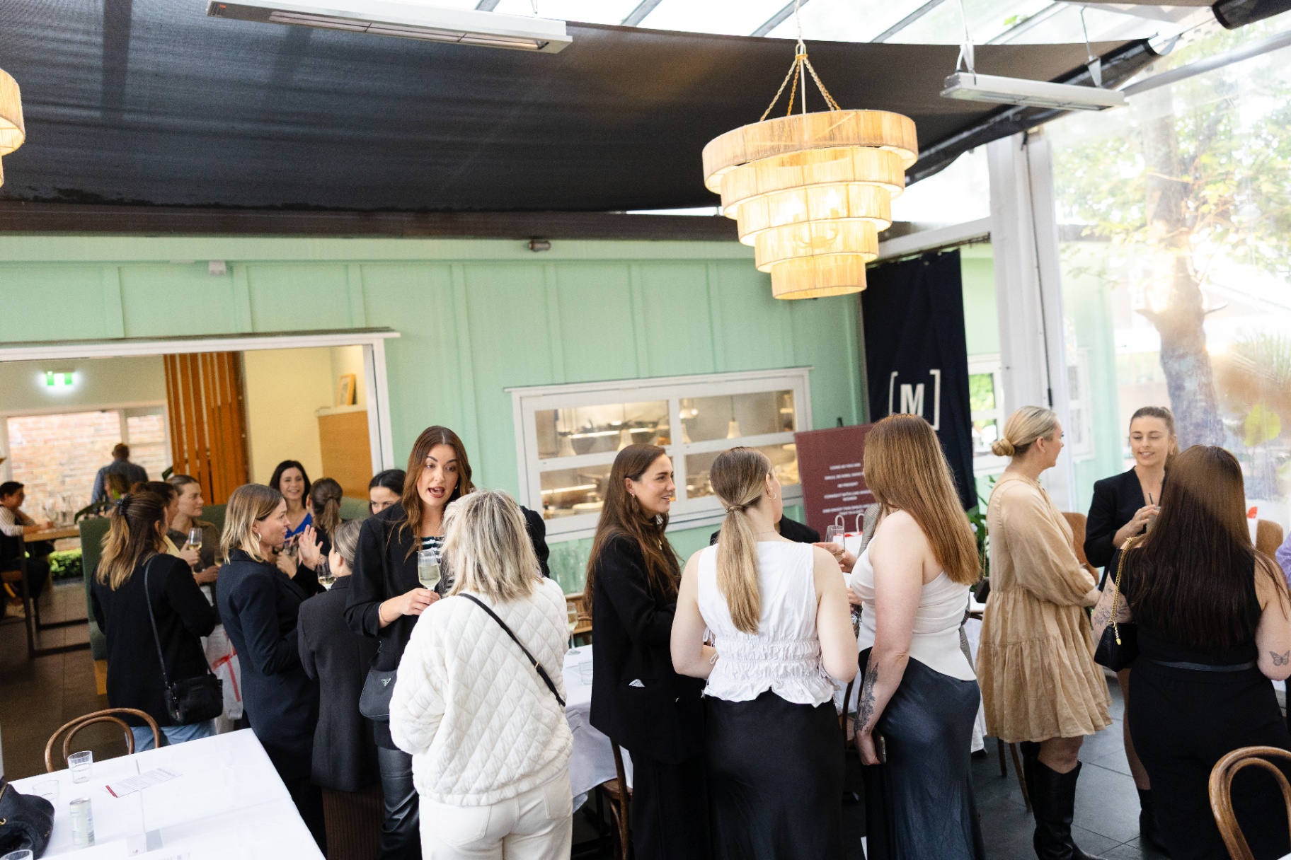 The room full of women networking before the panel