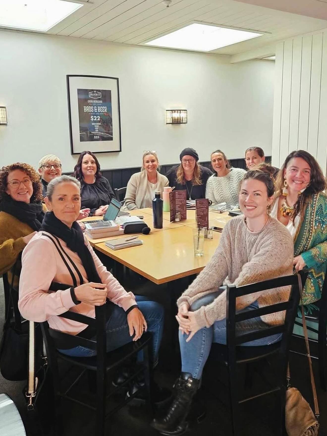 Women in business gathered around a table at a She Is Unleashed weekly group