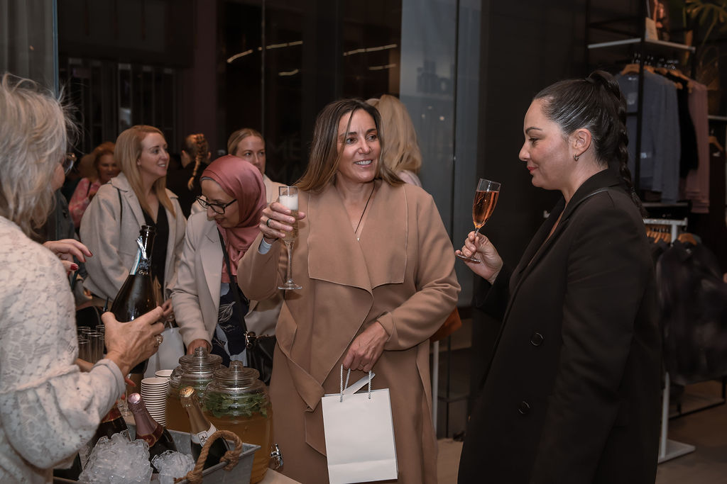 Women chatting with drinks in hand