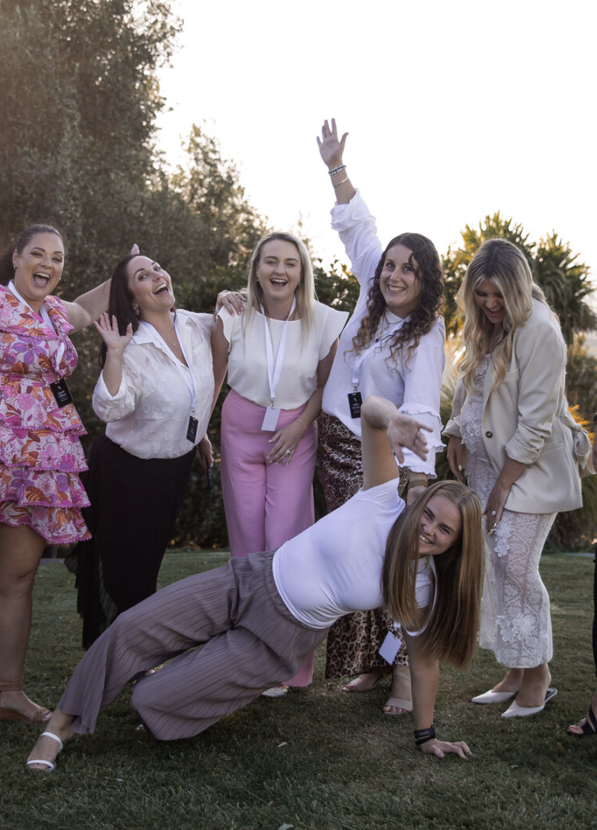 She Is Unleashed members laughing together at an outdoor event