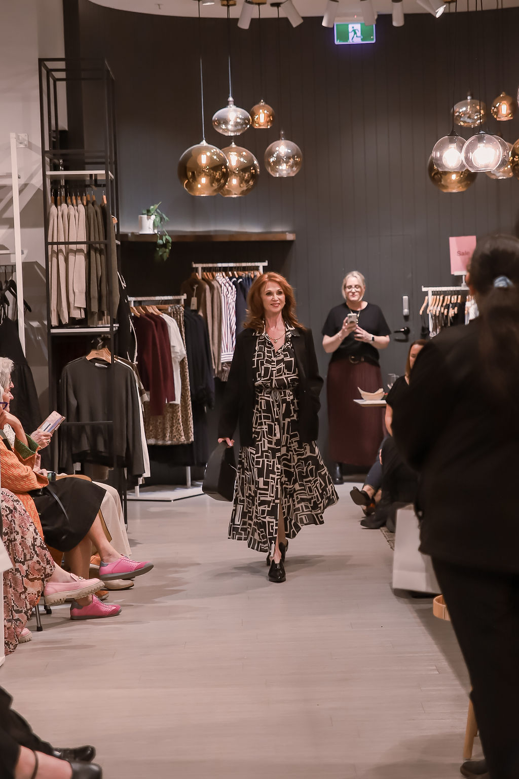 A model in a printed midi dress on the runway