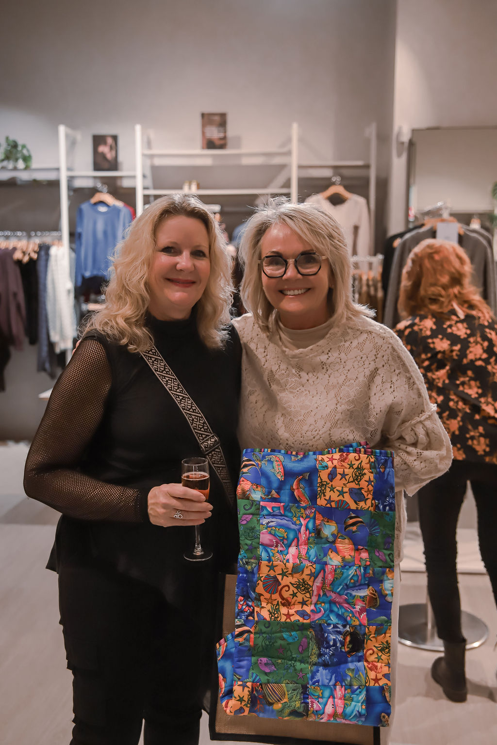 Two attendees with a donated raffle prize