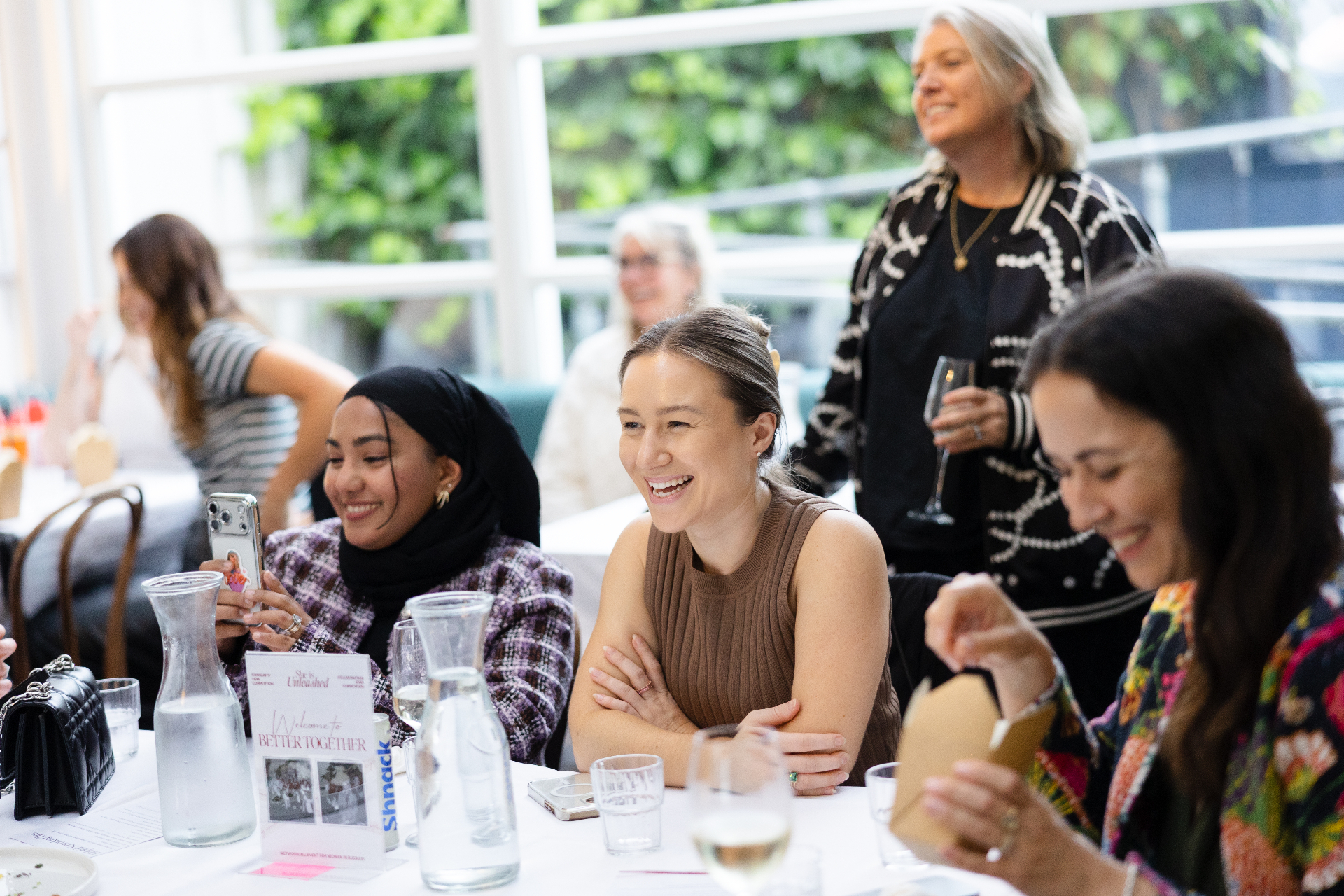 Guests laughing at the table during the Better Together panel