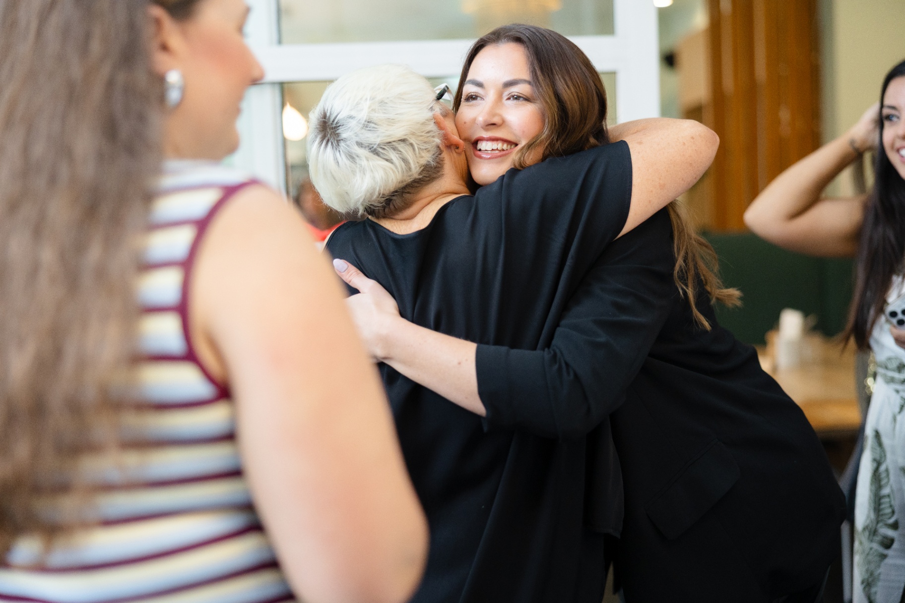 Two women sharing a warm hug at the event