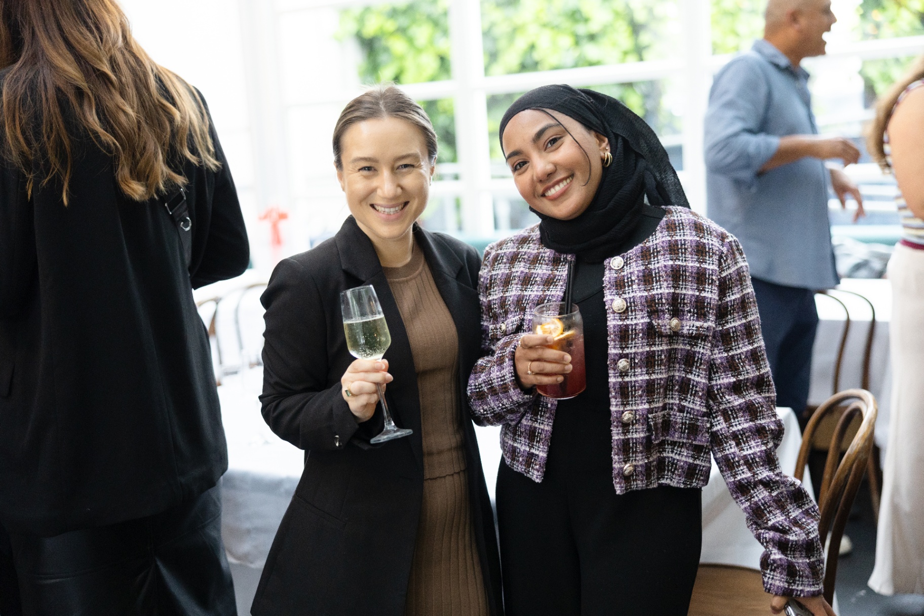 Two guests raising their drinks to the camera